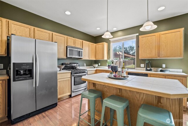 1735 SW 346th Pl, Federal Way, WA 98023 - kitchen featuring hanging light fixtures, light brown cabinets, a center island, and appliances with stainless steel finishes