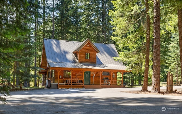 log-style house featuring a porch