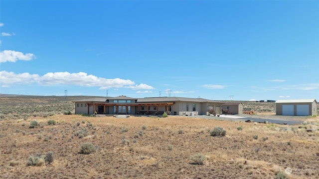 rear view of property featuring a garage