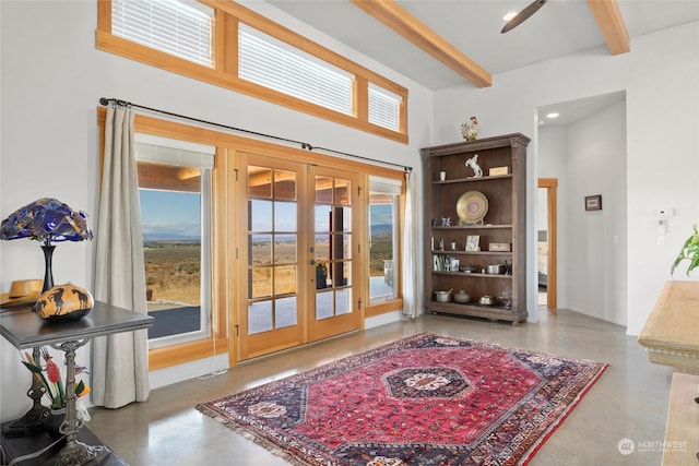 doorway featuring beamed ceiling and french doors