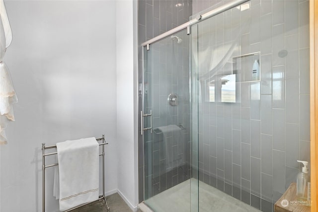 bathroom featuring a shower with door