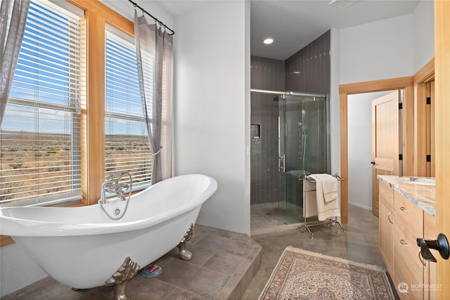 bathroom with vanity and separate shower and tub