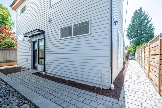 view of property exterior with a patio