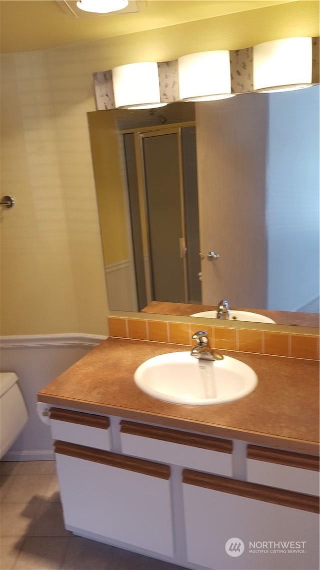 bathroom with tile patterned floors, toilet, and vanity