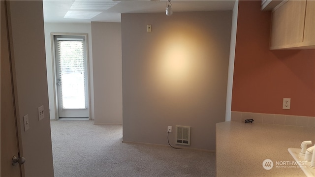 empty room with light carpet and plenty of natural light