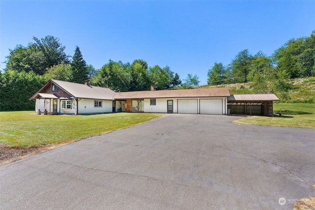 ranch-style house featuring a garage and a front lawn