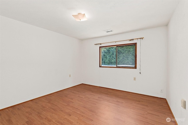 unfurnished room with hardwood / wood-style floors