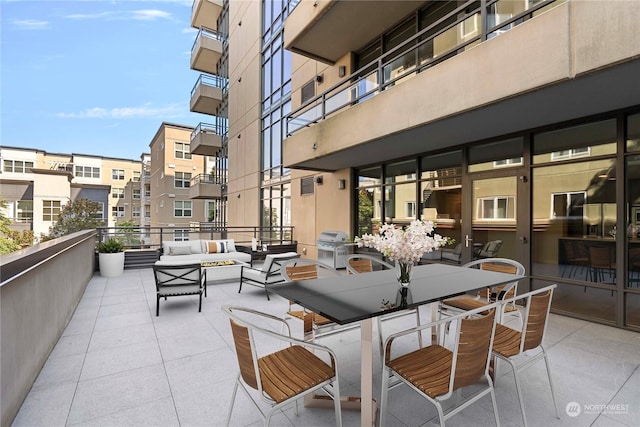 view of patio with grilling area, outdoor lounge area, and a balcony