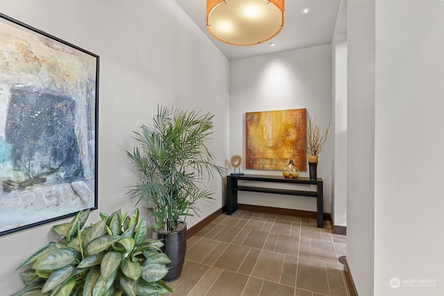 hallway with dark tile patterned floors