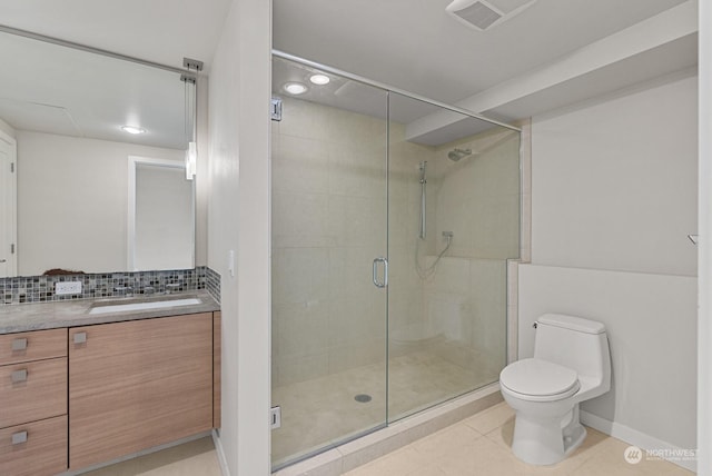 bathroom with tile patterned flooring, tasteful backsplash, an enclosed shower, vanity, and toilet