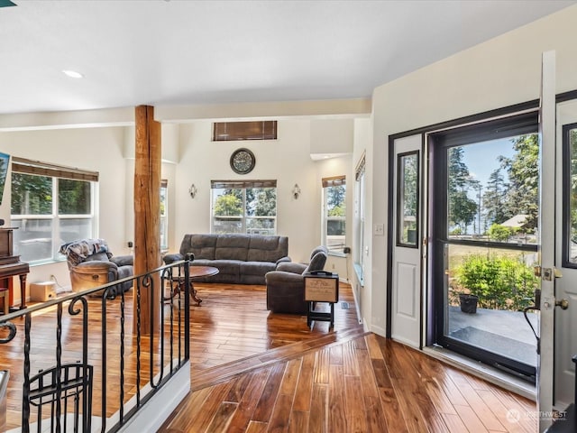 interior space with lofted ceiling, wood-type flooring, and a wealth of natural light