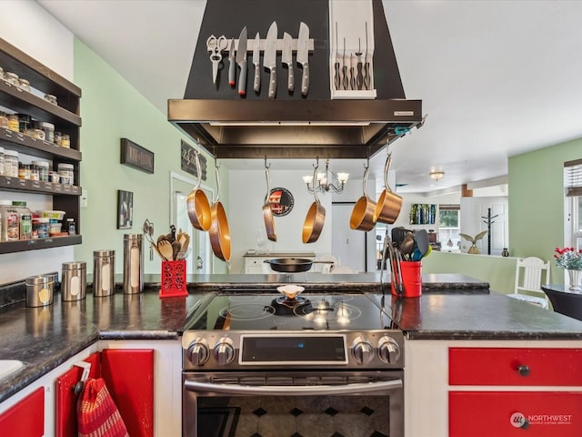 kitchen with electric stove, wall chimney exhaust hood, and an inviting chandelier