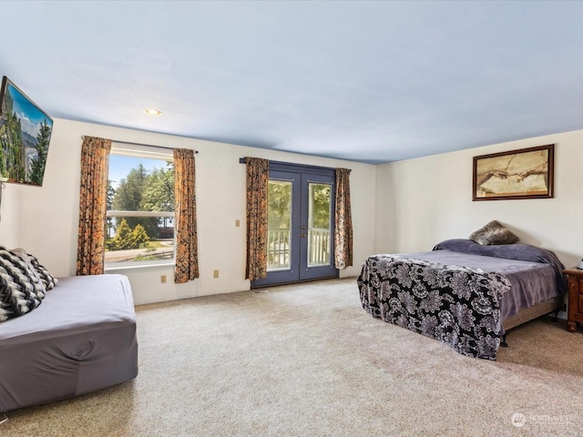 bedroom featuring access to exterior and light colored carpet