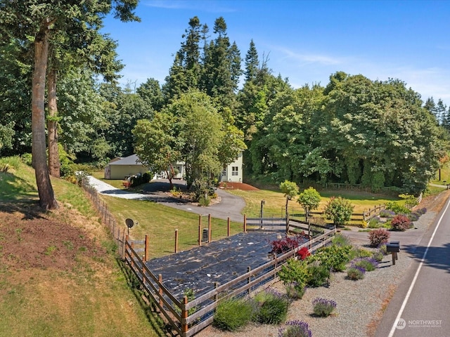 view of community with a garage and a yard