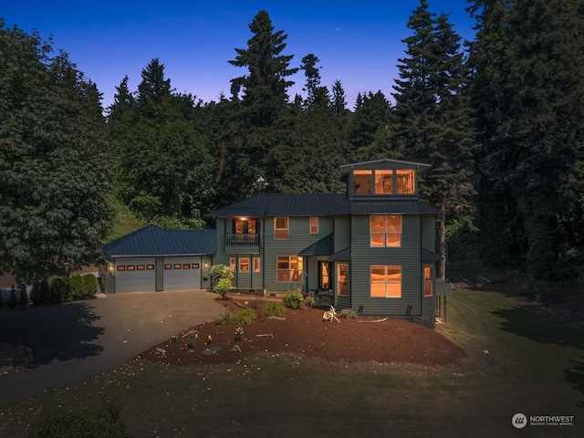 view of front of home featuring a balcony and a garage