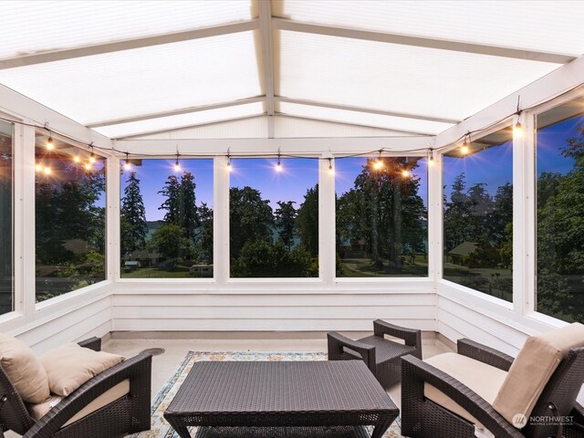 sunroom featuring an outdoor living space and vaulted ceiling