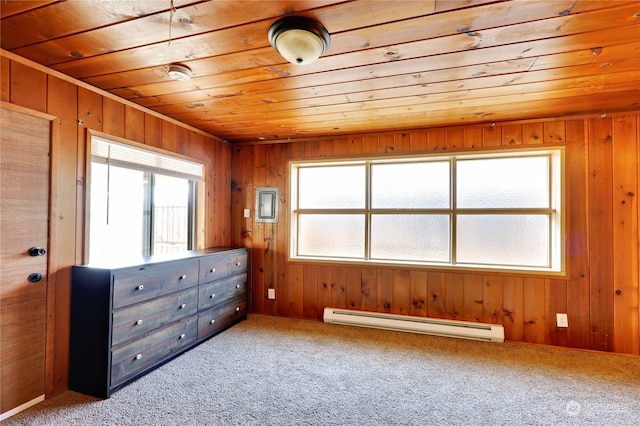 interior space featuring carpet floors, a baseboard radiator, wooden ceiling, and wood walls