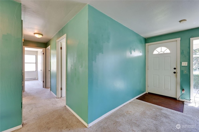 foyer entrance with light colored carpet