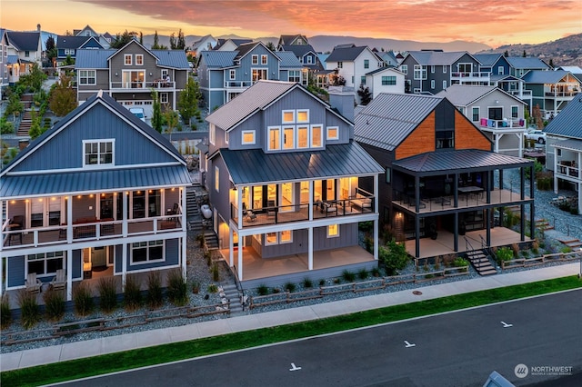 back house at dusk with a balcony