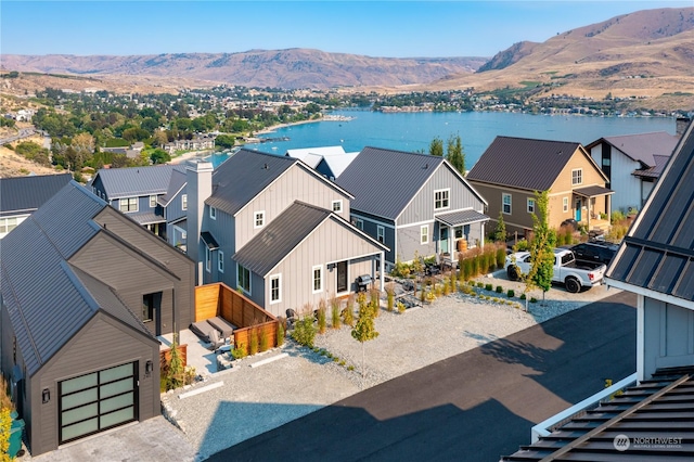 aerial view featuring a water and mountain view