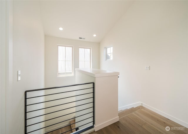 stairs featuring lofted ceiling and wood-type flooring