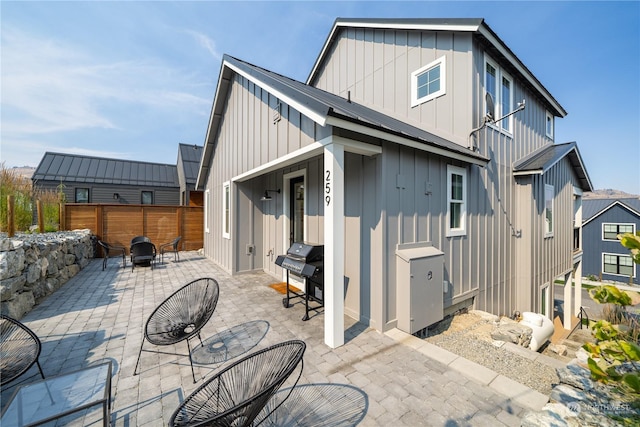 rear view of house featuring an outdoor fire pit and a patio