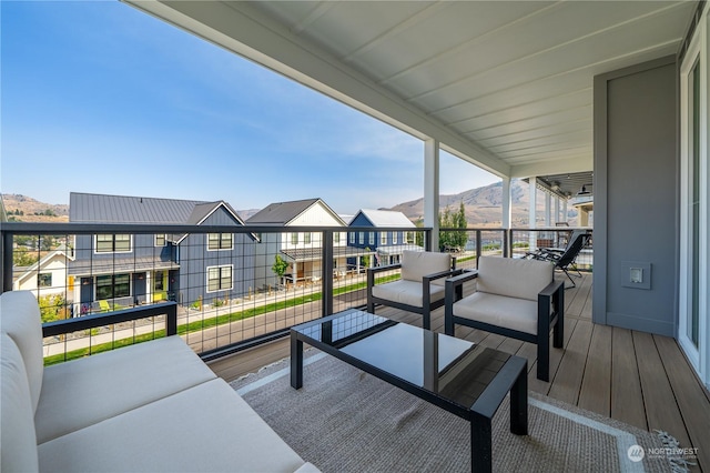 wooden terrace featuring an outdoor living space and a mountain view