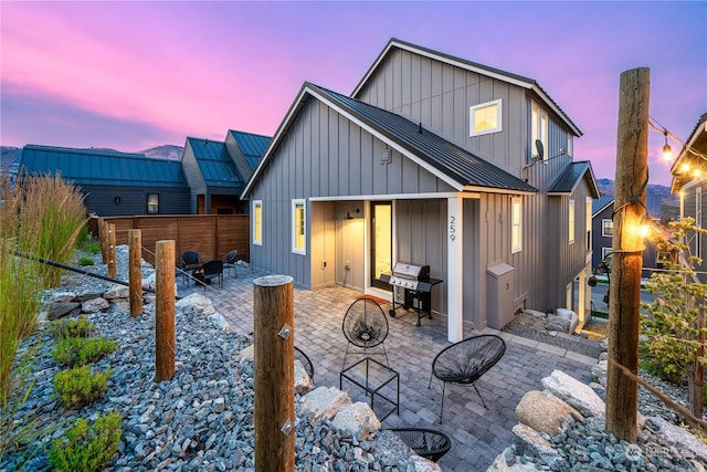 back house at dusk with a patio