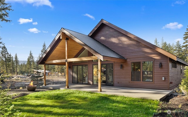 back of property featuring a yard and a patio area