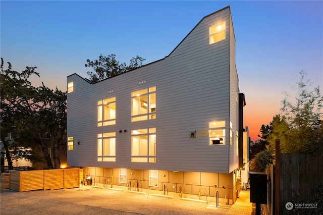 view of back house at dusk