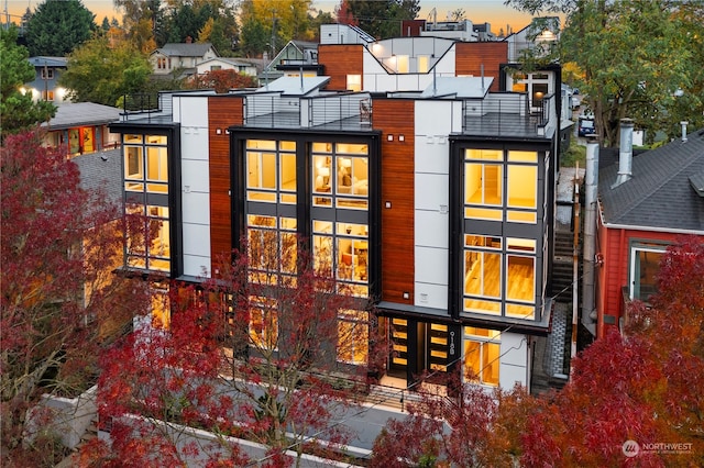 view of back house at dusk