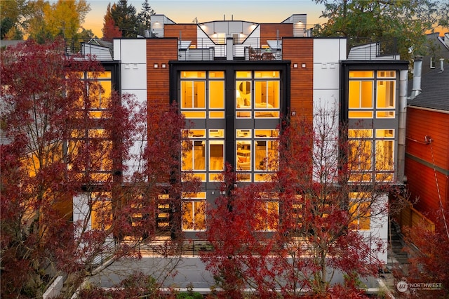 property exterior at dusk with a balcony