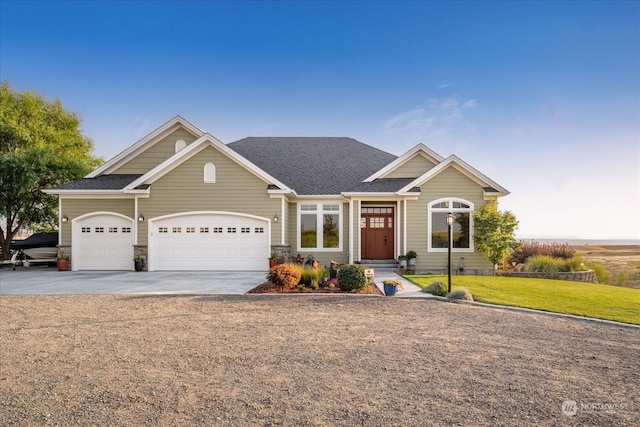 view of front of property featuring a front lawn and a garage