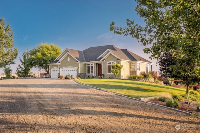 craftsman house featuring a front yard and a garage