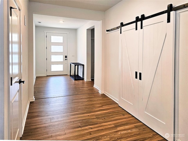 interior space featuring a barn door and dark hardwood / wood-style floors