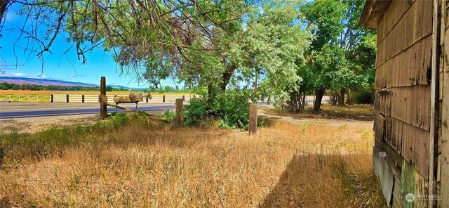 view of yard with a rural view