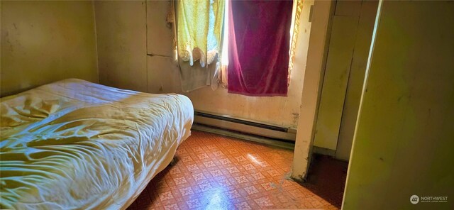 bedroom featuring tile patterned flooring and a baseboard radiator