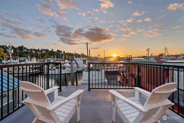 patio terrace at dusk featuring a water view