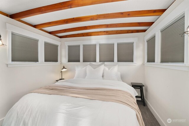 bedroom featuring lofted ceiling with beams