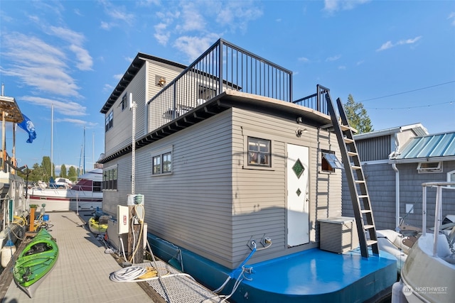 rear view of house with a balcony and central AC