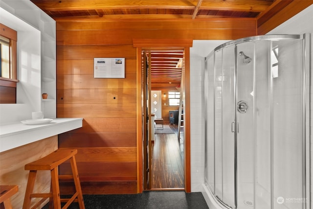 bathroom featuring a healthy amount of sunlight, hardwood / wood-style floors, and wood ceiling