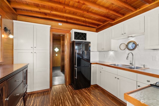 kitchen with black refrigerator, beam ceiling, tasteful backsplash, and wood ceiling