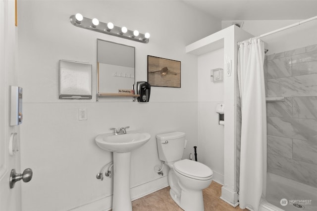 bathroom with walk in shower, tile patterned flooring, and toilet