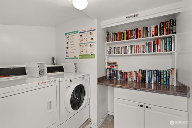 clothes washing area with washing machine and dryer and light tile patterned floors