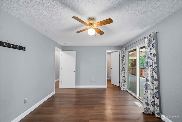 unfurnished room featuring dark hardwood / wood-style floors, a textured ceiling, and ceiling fan