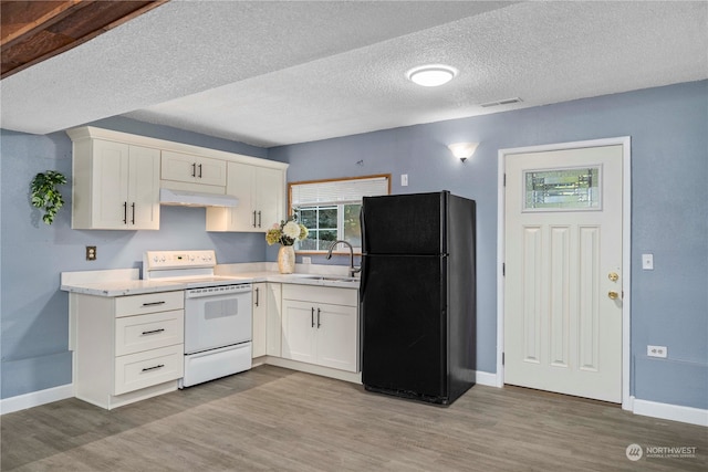 kitchen with light hardwood / wood-style floors, electric range oven, white cabinetry, and black fridge