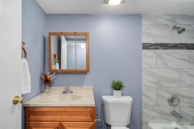 full bathroom with vanity, tiled shower / bath combo, and toilet