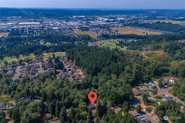 bird's eye view with a wooded view