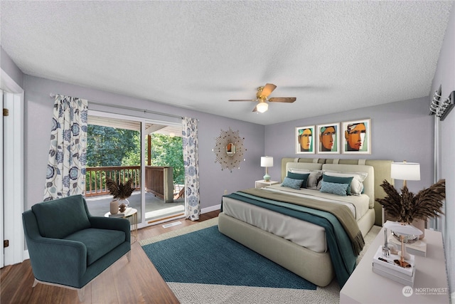 bedroom featuring a textured ceiling, access to exterior, wood-type flooring, and ceiling fan