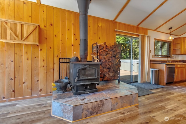 252 Snyder Rd, Packwood, WA 98361 - living room with light hardwood / wood-style floors, a wood stove, wood walls, and vaulted ceiling